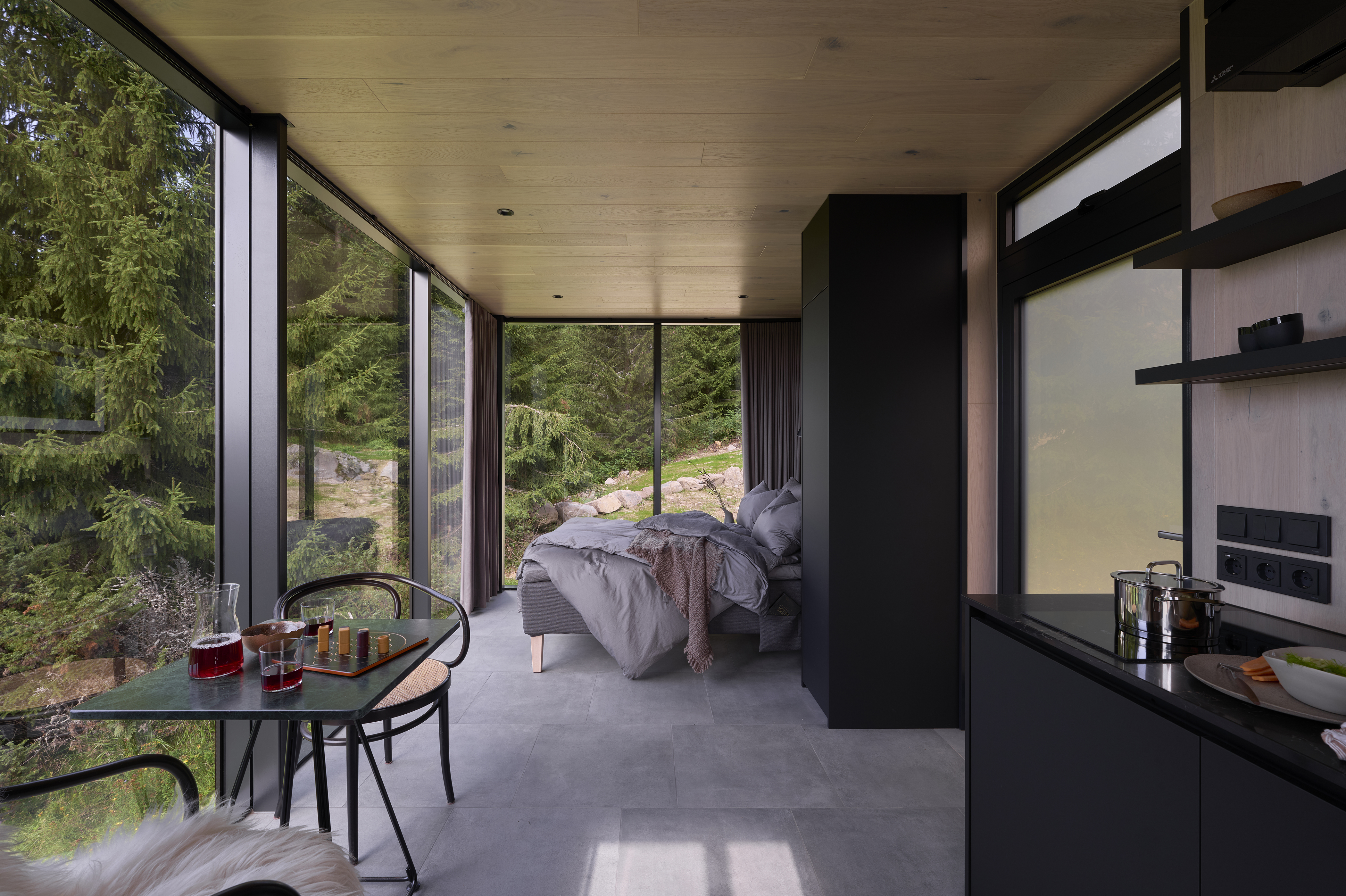 a room with a bed and a table and chairs